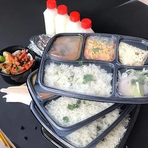 Tiffin boxes packed with rice and sides