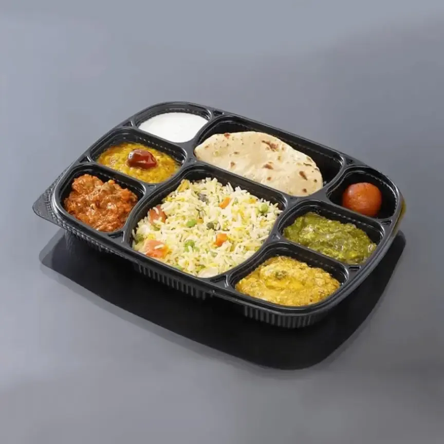 A compartment tray with rice, dal, sabzi, roti and sweet